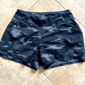Athleta girls record breaker 3” shorts.  Dark camo.